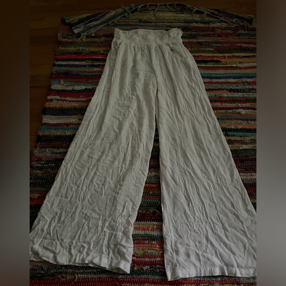 White linen pants with a wide leg and elastic waistband